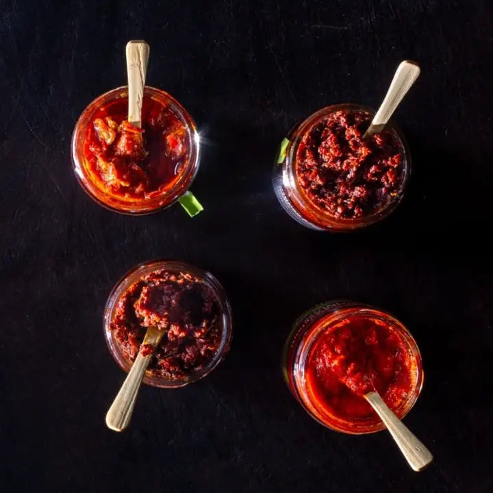 Authentic organic Tunisian harissa paste with rich spices and bold flavors, perfect for adding heat to Mediterranean dishes.