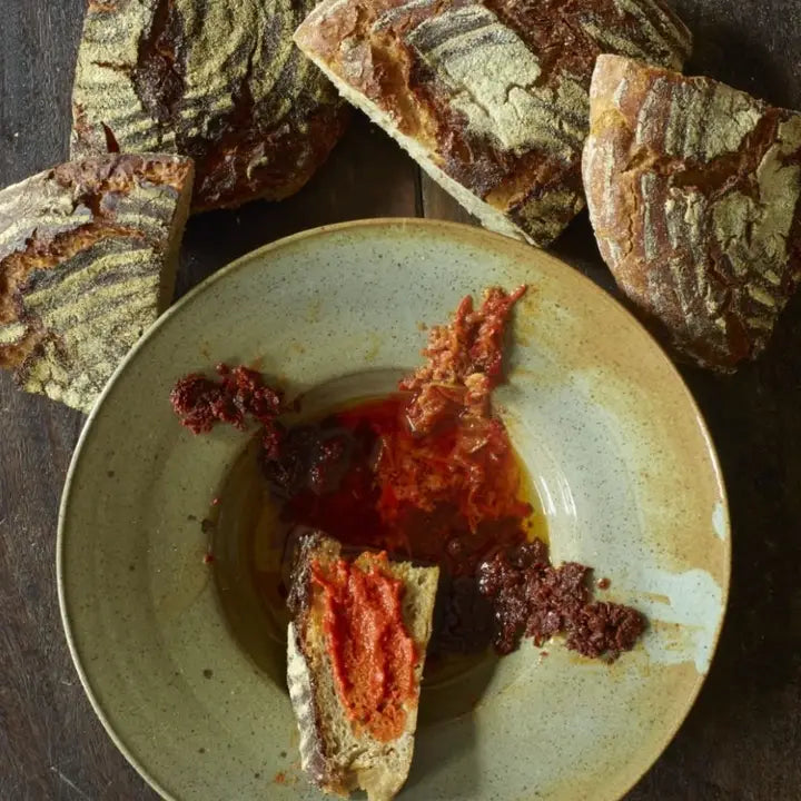 Authentic organic Tunisian harissa paste with rich spices and bold flavors, perfect for adding heat to Mediterranean dishes.